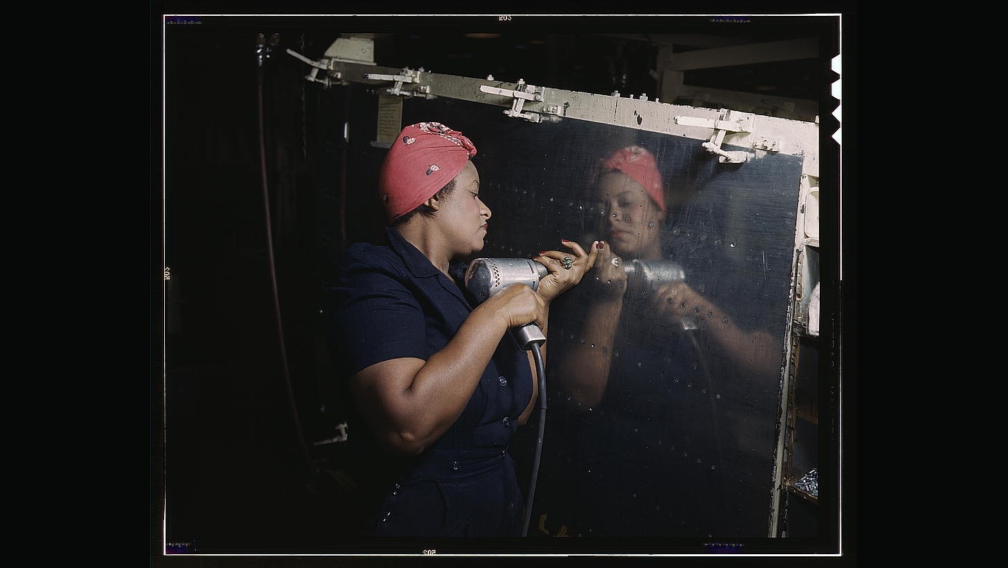 Operating a hand drill at Vultee-Nashville, woman is working on a "Vengeance" dive bomber, Tennessee